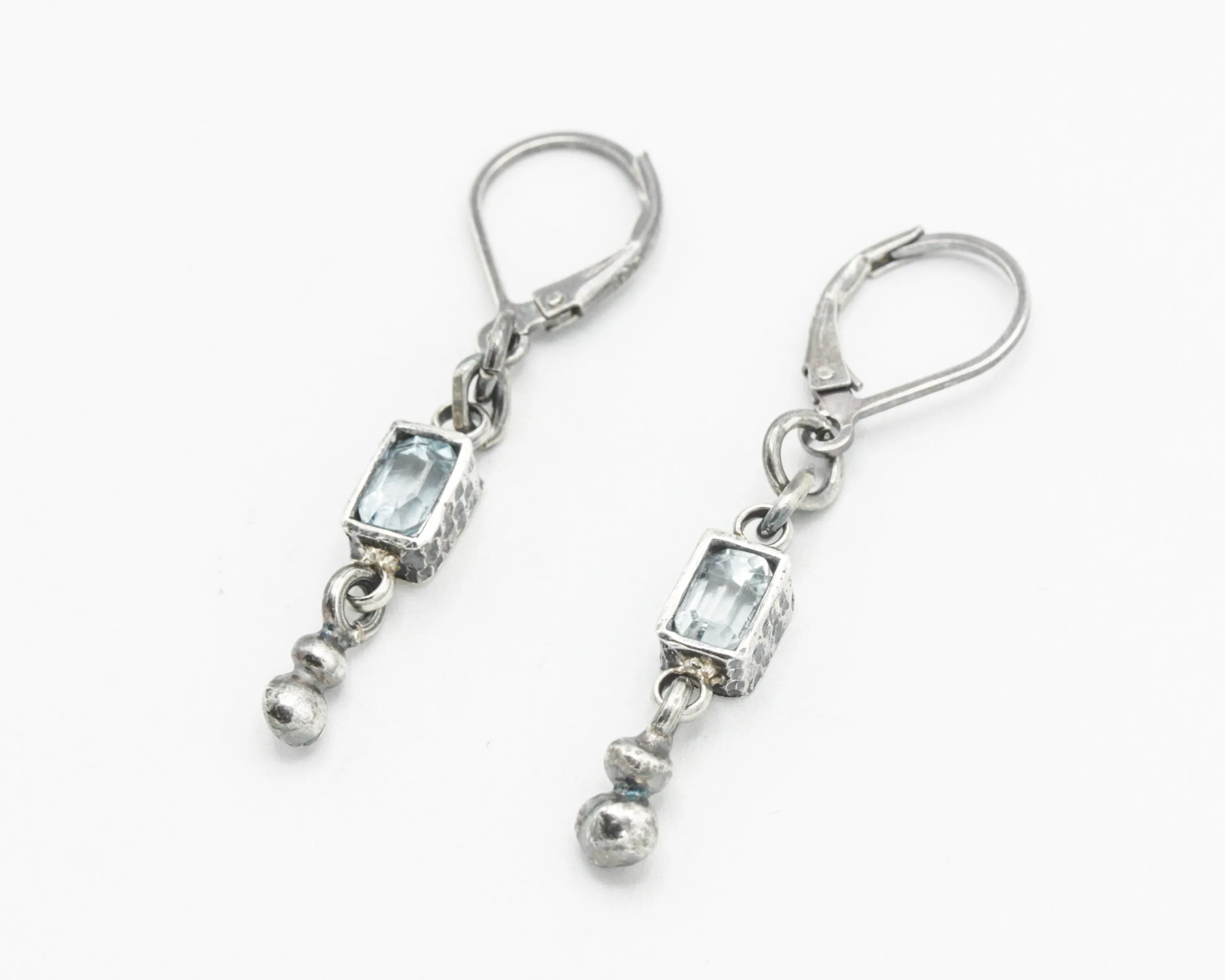 Earrings Princess cut Swiss blue topaz in silver bezel setting with silver peanut on sterling silver hooks style
