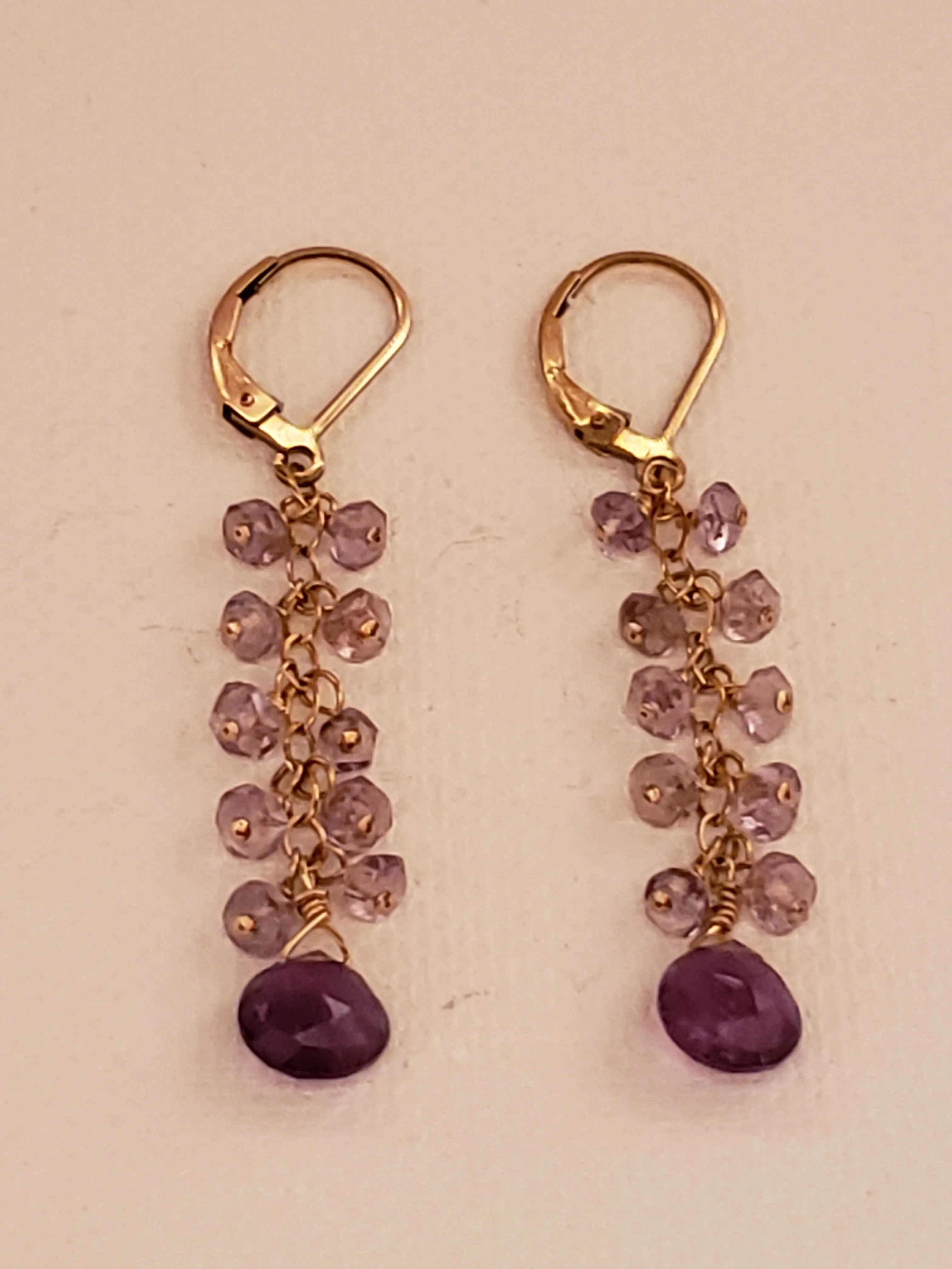 Faceted Amethyst Tear Drop Anchors a Cascade of Amethyst Gemstones on 14kt Gold-Filled Lever Back Earrings.