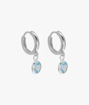 Huggie hoop earrings with round blue topaz