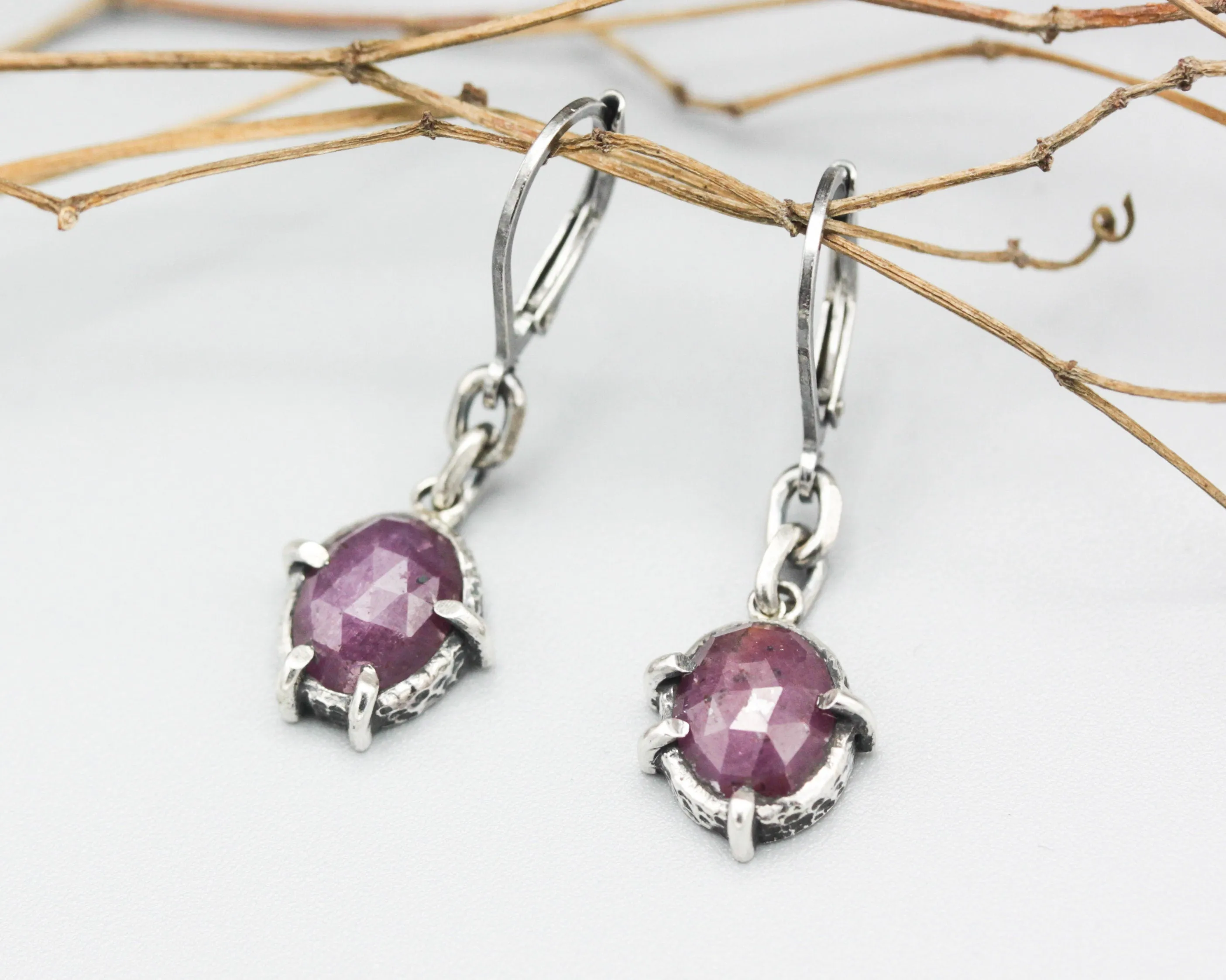 Pink sapphire oval faceted earrings in bezel and prongs setting with silver chain on oxidized sterling silver hooks