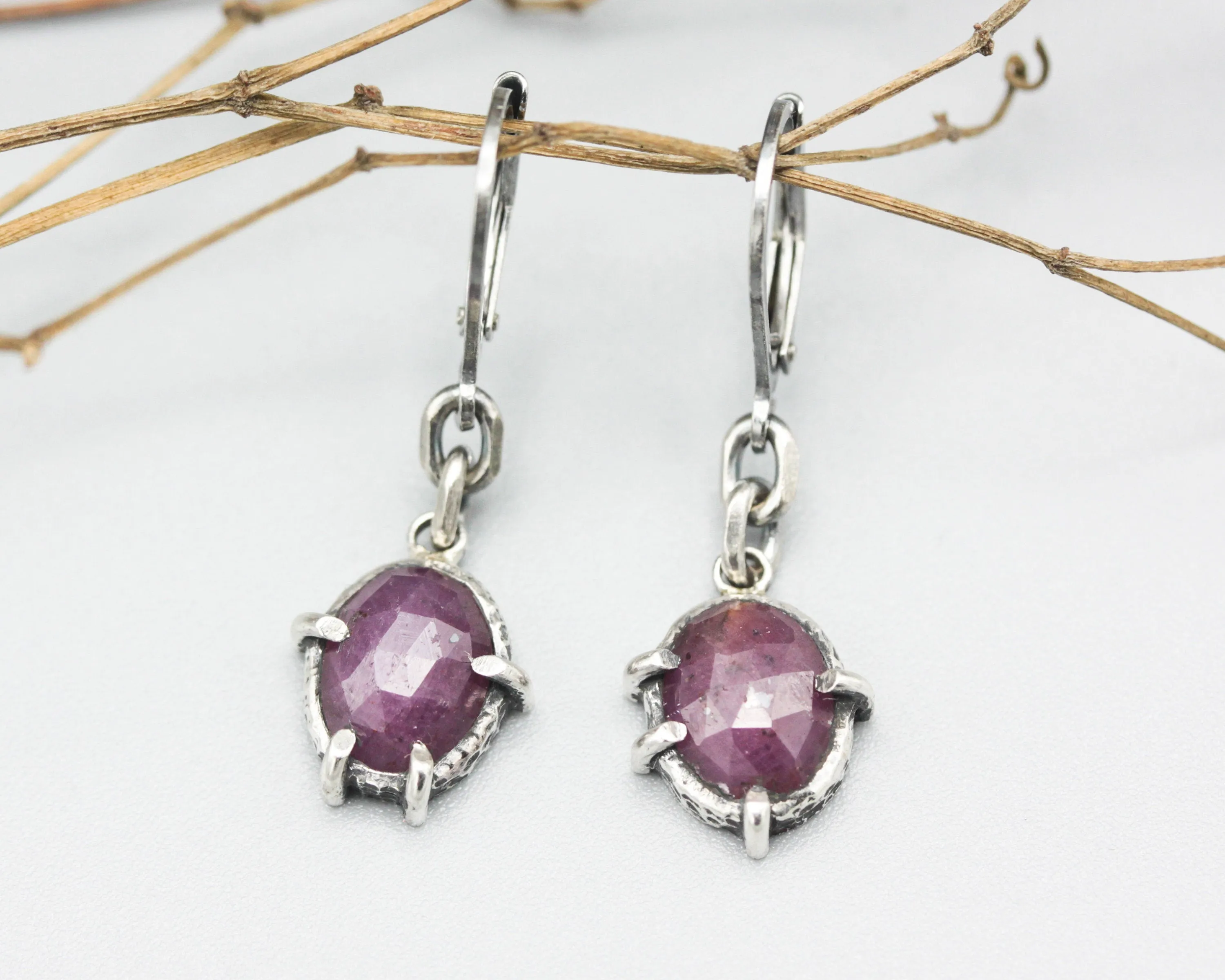 Pink sapphire oval faceted earrings in bezel and prongs setting with silver chain on oxidized sterling silver hooks