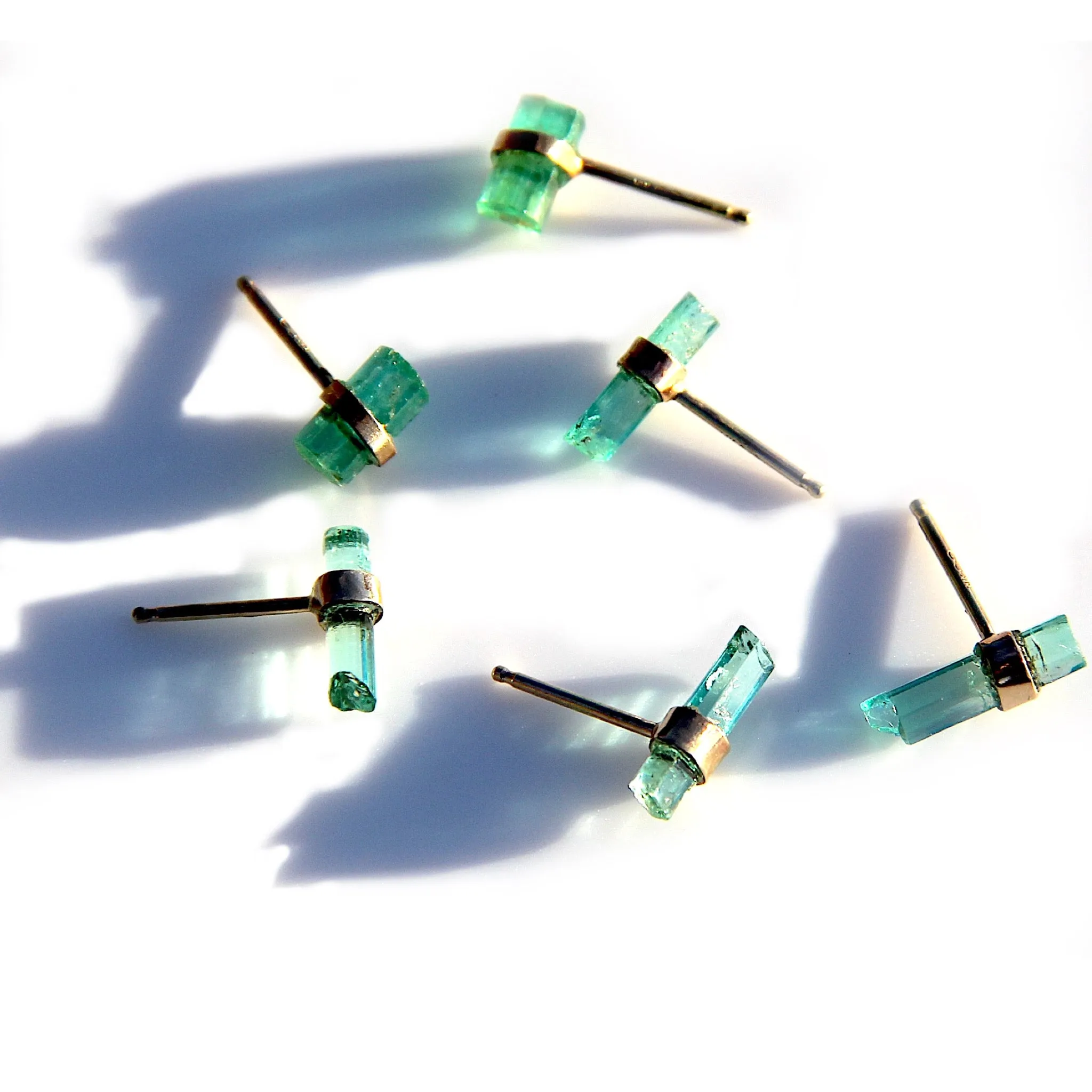 Raw emerald stud earrings in gold